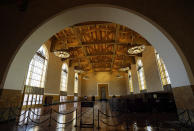 The interior of Union Station in Los Angeles appears on March 23, 2021. The Oscars are headed to the historic site for the first time this year. With wide open spaces and 65-foot high ceilings, it’s ideal for a big crew and cameras. It’s been used in car commercials, reality shows and procedurals. But its beamed ceilings, Spanish tile floors and regal bronze chandeliers really shine in cinema where it’s played train stations, banks, police stations, clubs and airports. (AP Photo/Chris Pizzello)