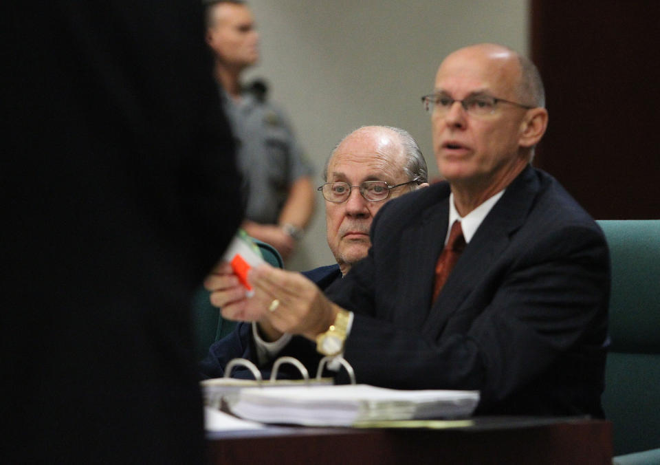 Former Tampa Police captain Curtis Reeves, Jr., left, sits beside his defense attorney Richard Escobar, right, during his bond reduction hearing before Circuit Judge Pat Siracusa at the Robert D. Sumner Judicial Center in Dade City Friday, Feb. 7, 2014. Reeves is suspected of fatally shooting Chad Oulson, 43, and wounding his wife, Nicole, 33, during an argument Jan. 13 over texting at the Cobb Grove 16 theater in Wesley Chapel, Fla. (AP Photo/Pool Tampa Bay Times, Brendan Fitterer, Pool)