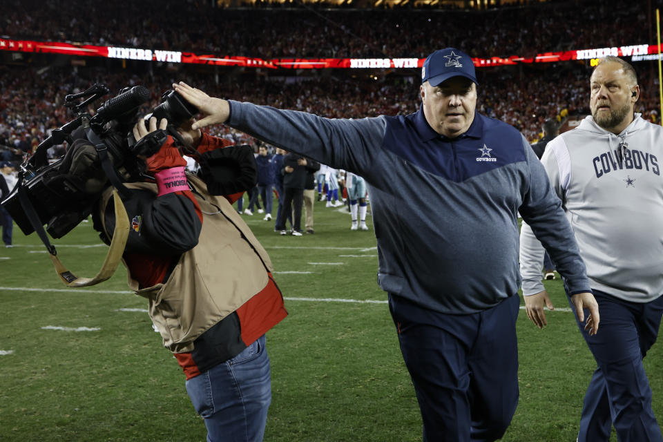 Dallas Cowboys head coach Mike McCarthy pushes a cameraman away while walking off the field after an NFL divisional round playoff football game against the San Francisco 49ers in Santa Clara, Calif., Sunday, Jan. 22, 2023. (AP Photo/Josie Lepe)