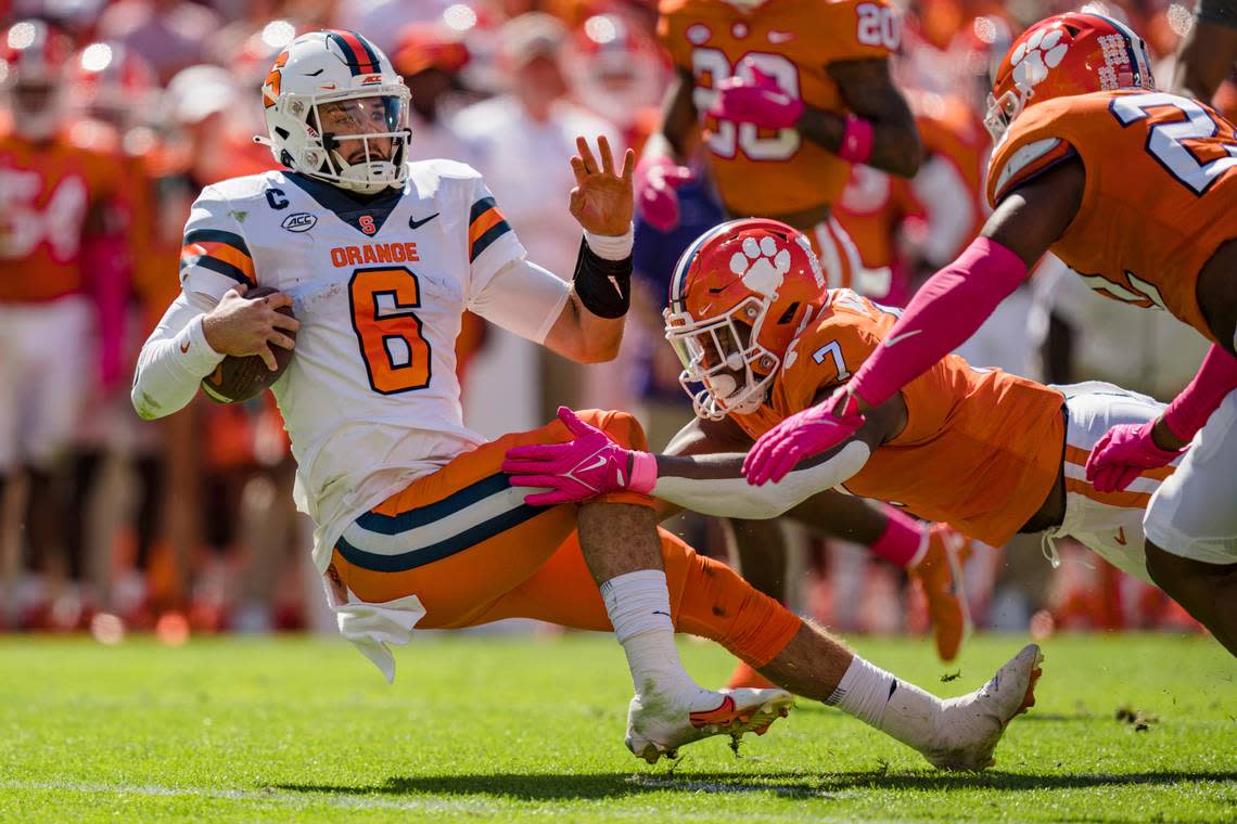 Clemson defensive end Justin Mascoll (7) tackles Syracuse quarterback Garrett Shrader (6) in the first half during an NCAA college football game on Saturday, Oct. 22, 2022, in Clemson, S.C. (AP Photo/Jacob Kupferman)