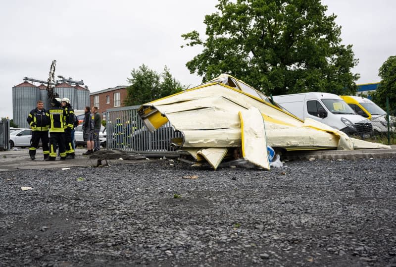 A sectional door of a hall lies on the ground after a tornado tore the door and parts of the ceiling of the hall away after a heavy storm in Telgte. Guido Kirchner/dpa