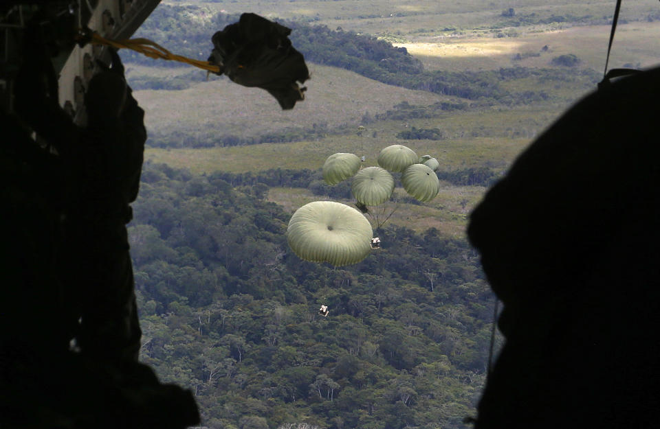 FILE - Food is airdropped from a military transport aircraft to the Surucucu military base, to be delivered to Yanomami Indigenous people, in Alto Vista, Roraima state, Brazil, Jan 26, 2023. Severe malnutrition and disease, particularly malaria, are decimating the Yanomami population in Brazil's Amazon rainforest. (AP Photo/Edmar Barros, File)