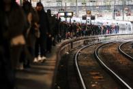 Commuters walk on a platform at Gare Saint-Lazare train station in Paris