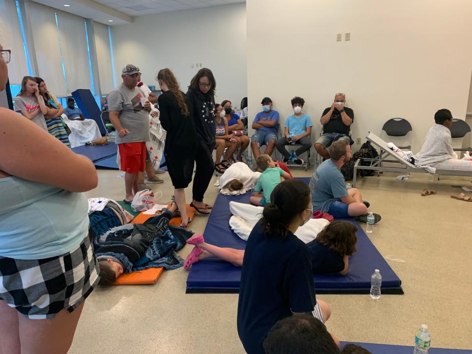 Family and friends await news at the American Red Cross reunification site June 24 in Surfside, Fla.