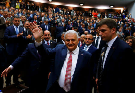 Turkey's new Prime Minister Binali Yildrim greets members of parliament from his ruling AK Party (AKP) as he arrives for a meeting at the Turkish parliament in Ankara, Turkey, May 24, 2016. REUTERS/Umit Bektas
