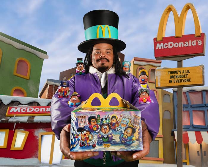 Kerwin Frost holding a McDonald's box and wearing a top hat