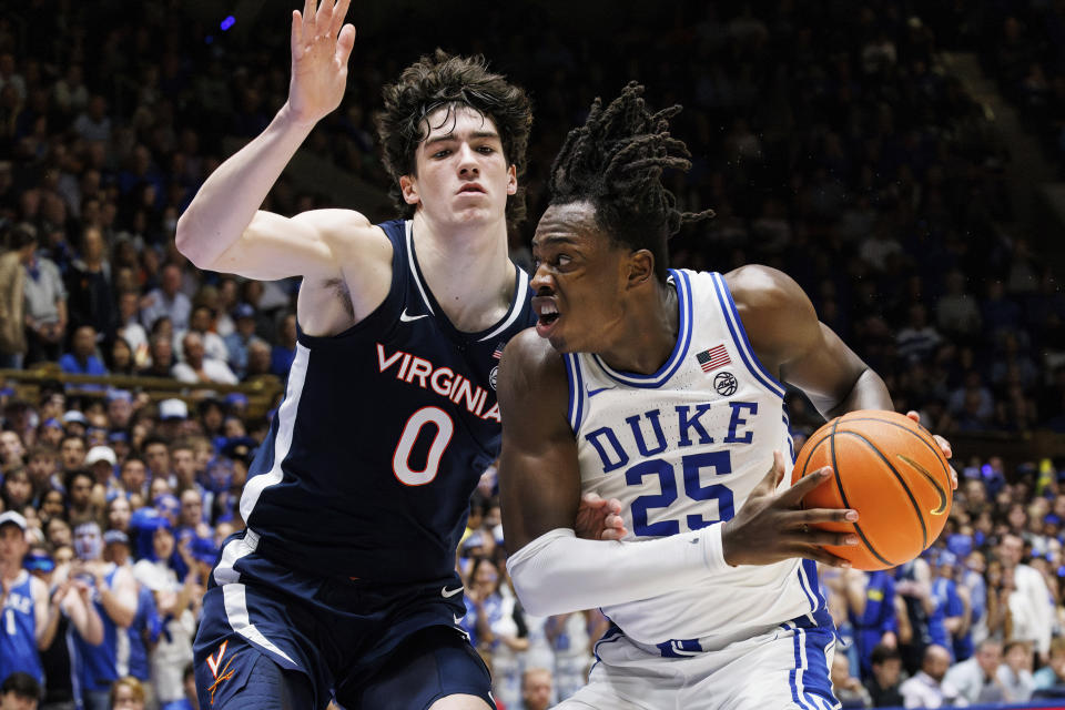 Duke's Mark Mitchell (25) is defended by Virginia's Blake Buchanan (0) during the second half of an NCAA college basketball game in Durham, N.C., Saturday, Mar. 2, 2024. (AP Photo/Ben McKeown)