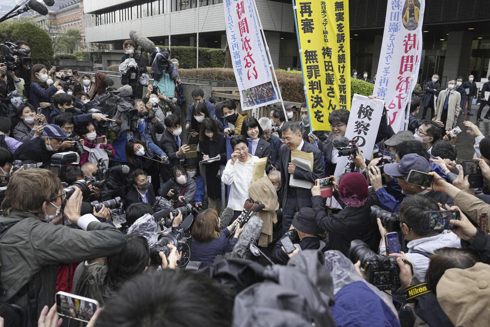 Hideko Hakamada, center left in white cloth, sister of Iwao Hakamada, is surrounded by media and others following a court decision at Tokyo Hight Court in Tokyo Monday, March 13, 2023. Tokyo’s high court on Monday ordered a retrial for the 87-year-old former boxer who has been on death row for nearly six decades after his murder conviction that his lawyers said was based on forced confession and fabricated evidence. (Kyodo News via AP)