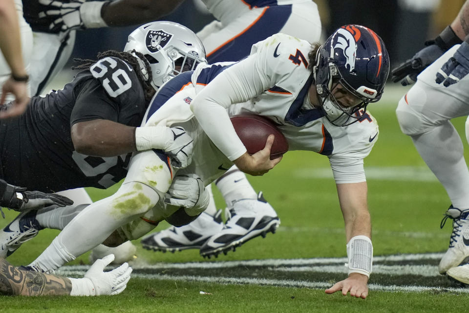 Las Vegas Raiders defensive tackle Adam Butler (69) sacks Denver Broncos quarterback Jarrett Stidham (4) during the second half of an NFL football game, Sunday, Jan. 7, 2024 in Las Vegas. (AP Photo/John Locher)