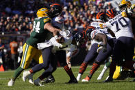 Chicago Bears quarterback Justin Fields tries to escape the grasp of Green Bay Packers defensive end Dean Lowry during the second half of an NFL football game Sunday, Oct. 17, 2021, in Chicago. The Packers won 24-14.(AP Photo/David Banks)