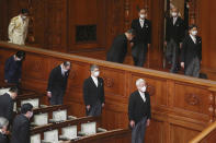 Japan's Emperor Naruhito, right, wearing a face mask to protect against the coronavirus arrives to read a statement to formally open an extraordinary Diet session at the upper house of parliament in Tokyo, Monday, Oct. 26, 2020. (AP Photo/Koji Sasahara)