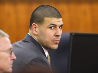 FILE PHOTO - Former NFL player Aaron Hernandez and defense attorney Charles Rankin wait in the courtroom during the jury deliberation in his murder trial at the Bristol County Superior Court in Fall River, Massachusetts, April 10, 2015.  REUTERS/CJ Gunther/Pool/File Photo