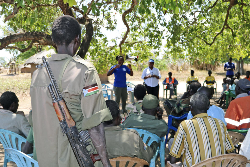 In Tuesday Feb. 26 2019 photo, health workers give a training presentation about how to detect and prevent the spread of Ebola, in an army barracks outside South Sudan's town of Yei. With the deadly Ebola outbreak in Congo now an international emergency, neighboring South Sudan and its war-weakened health system is a major concern, especially after one case was confirmed near its border. Health experts say there is an urgent need to increase prevention efforts. (AP Photo/Sam Medrick)