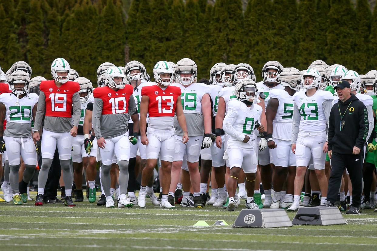 Oregon running back Bucky Irving (center) fires up the team during practice with the Ducks Tuesday, April 4, 2023. 