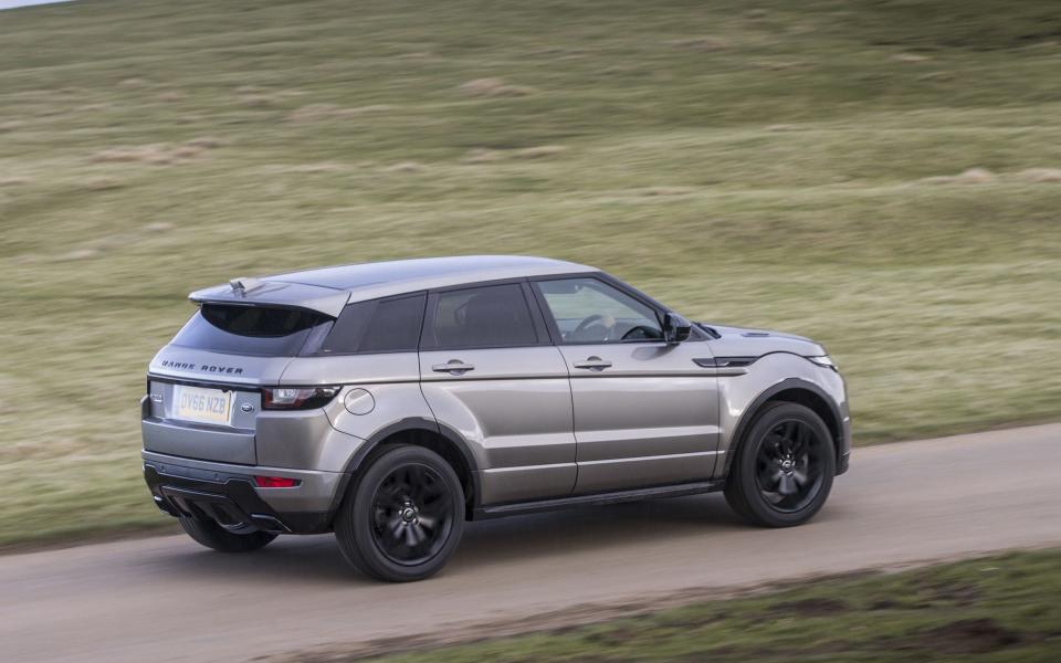 Range Rover Evoque being driven between two stretches of green grass