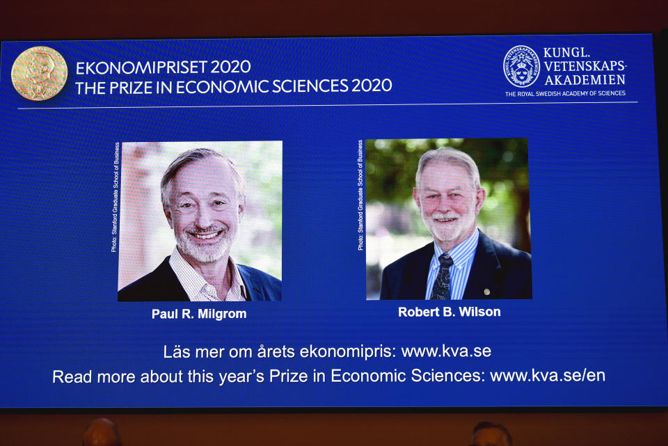 Winners of the Sveriges Riksbank Prize in Economic Sciences in Memory of Alfred Nobel for 2020 at a press conference in Stockholm, Monday Oct. 12, 2020. Americans Paul R. Milgrom, left, and Robert B. Wilson have won the Nobel Prize in economics for "improvements to auction theory and inventions of new auction formats." (Anders Wiklund/TT via AP)