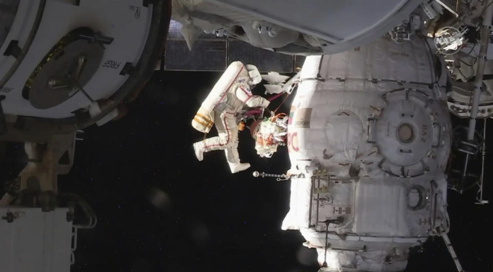 In this image from video made available by NASA, Russian cosmonaut Oleg Kononenko performs a spacewalk outside the International Space Station on Tuesday, Dec. 11, 2018. Kononenko and Sergei Prokopyev are inspecting a section where a mysterious leak appeared on Aug. 30. (NASA via AP)
