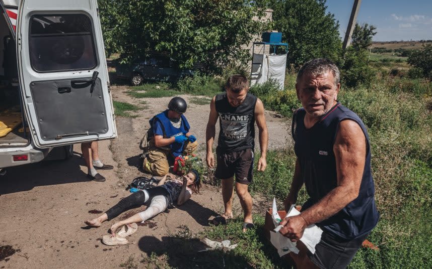 A woman lies injured in the village of Opytne in the Donbas region yesterday. CREDIT: ANADOLU - ANADOLU agency
