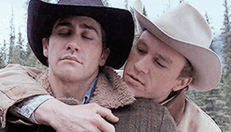 Jake Gyllenhaal being held by Heath Ledger