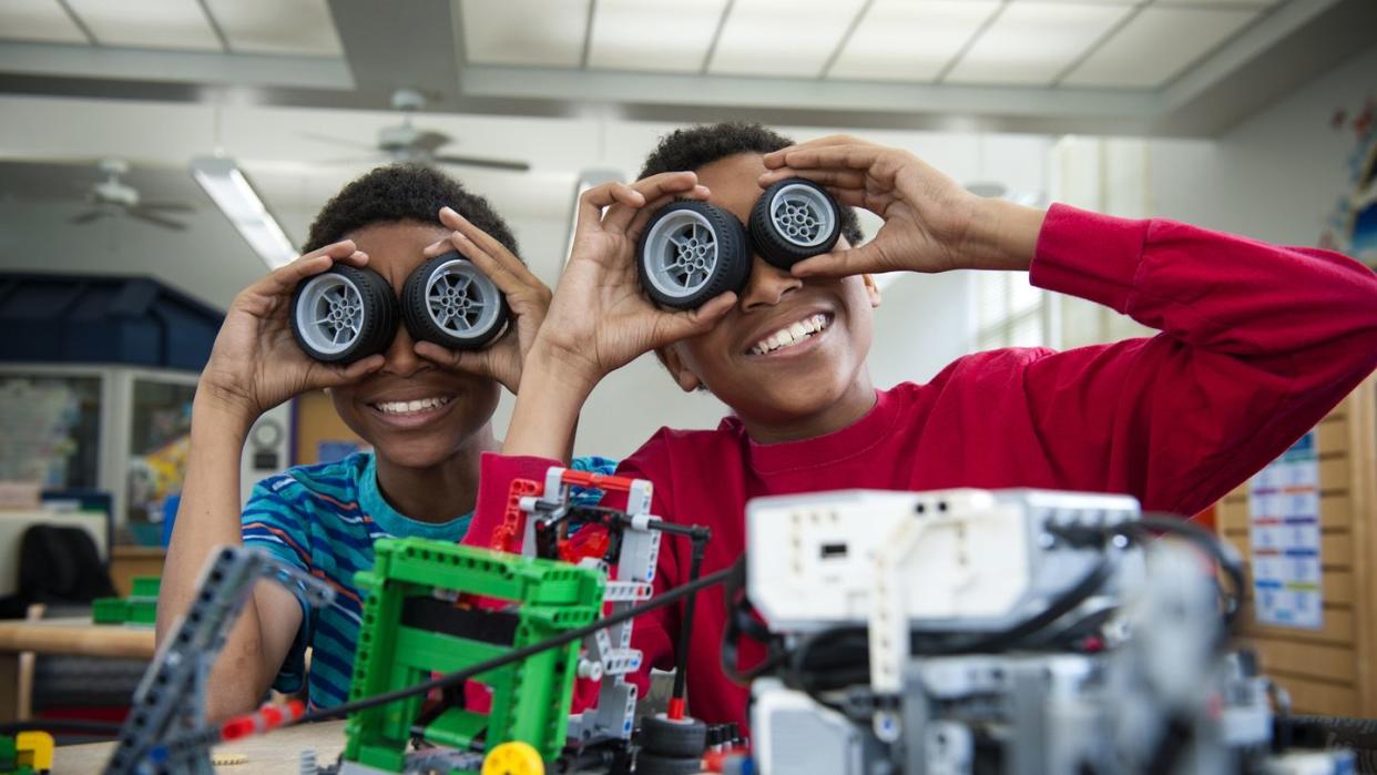 boys playing with toy wheels