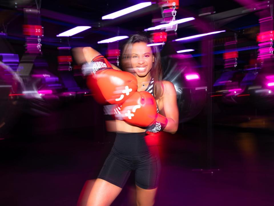 Rachelle Dejean smiles while in a Rumble boxing class.