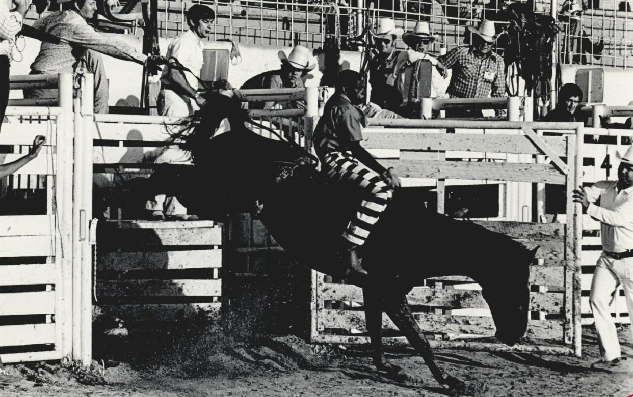 This photo from the 1984 prison rodeo in McAlester shows an inmate competing in the bronc riding competition.