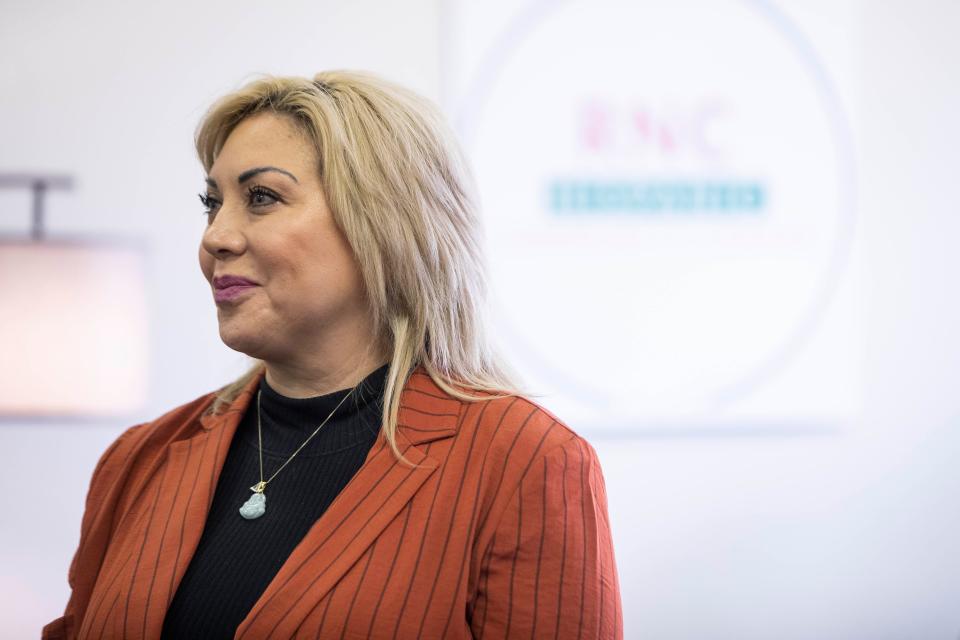 Mercedes Provencio Hollister, Regional Hispanic Event Coordinator, listens to speakers during the opening of a Republican Party Hispanic outreach center on Wednesday, Sept. 7, 2022, at the center.