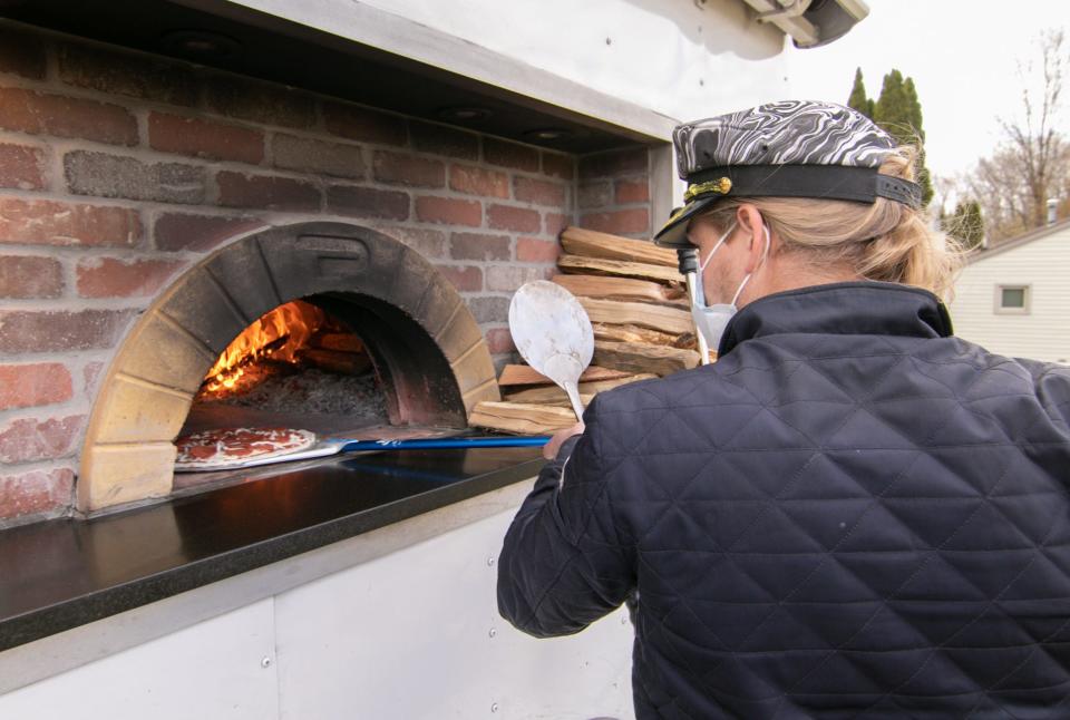 “Captain” Nick Mannisto fires a pepperoni pizza in his food truck’s wood oven Thursday, April 22, 2021 on Scenic Drive in Brighton Township. Mannisto will be part of the Food Truck Tuesdays in front of the historical Livingston County Courthouse this summer.