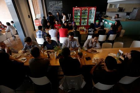 Employees of San Francisco-based software company Wizeline, share lunch at the company's canteen in Guadalajara, Mexico October 5, 2017. Picture taken October 5, 2017. REUTERS/Daniel Becerril