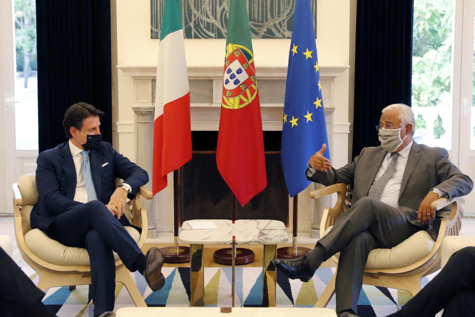 Italy's Prime Minister Giuseppe Conte is received by Portugal's Prime Minister Antonio Costa, right, at the Sao Bento palace in Lisbon, Tuesday, July 7, 2020. Southern European countries are mounting a show of strength as negotiations over how much money they get from the EU, and in what form, comes to a crunch. (AP Photo/Armando Franca)