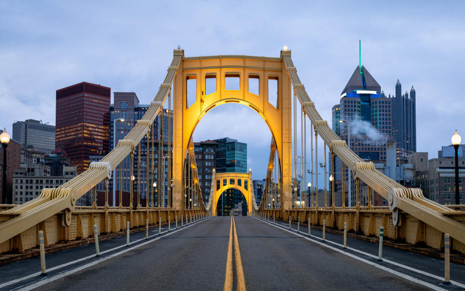 A golden bridge leading to a city