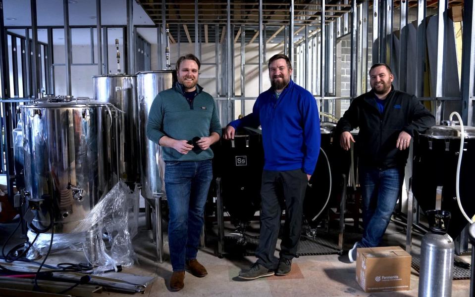 Left to right A.J. Kilroy, Nate Tessier and Robert Russell in their yet-to-be complete English-style brewery in Rolfe Square in Cranston.