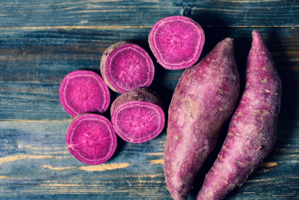 Vibrant purple sweet potatoes on a table.