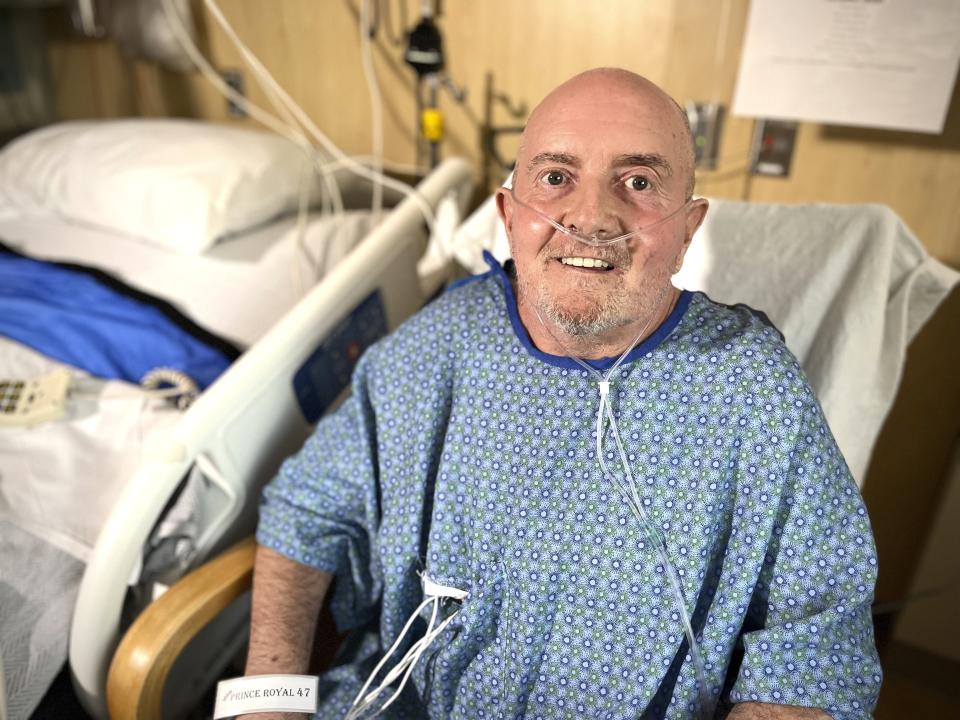 In this image provided UCHealth Memorial Hospital Central, Club Q shooting survivor Ed Sanders poses on Monday, Nov. 21, 2022, in Colorado Springs Colo. Sanders, 63, says he wants to be resilient and won't be "taken out by some sick person.” He has been a patron of Club Q for 20 years — and was even there on the club's opening night. (Sonya Doctorian/UCHealth Memorial Hospital Central via AP)