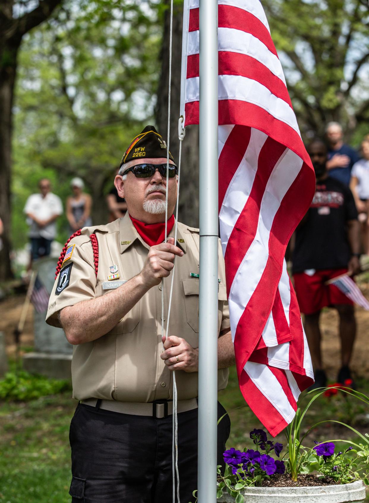 Chaplain Schuyler, of VFW Post 2260 in Oconomowoc, raises the flag from half-staff during the Memorial Day Remembrance ceremony at La Belle Cemetery on Monday, May 25, 2020.
