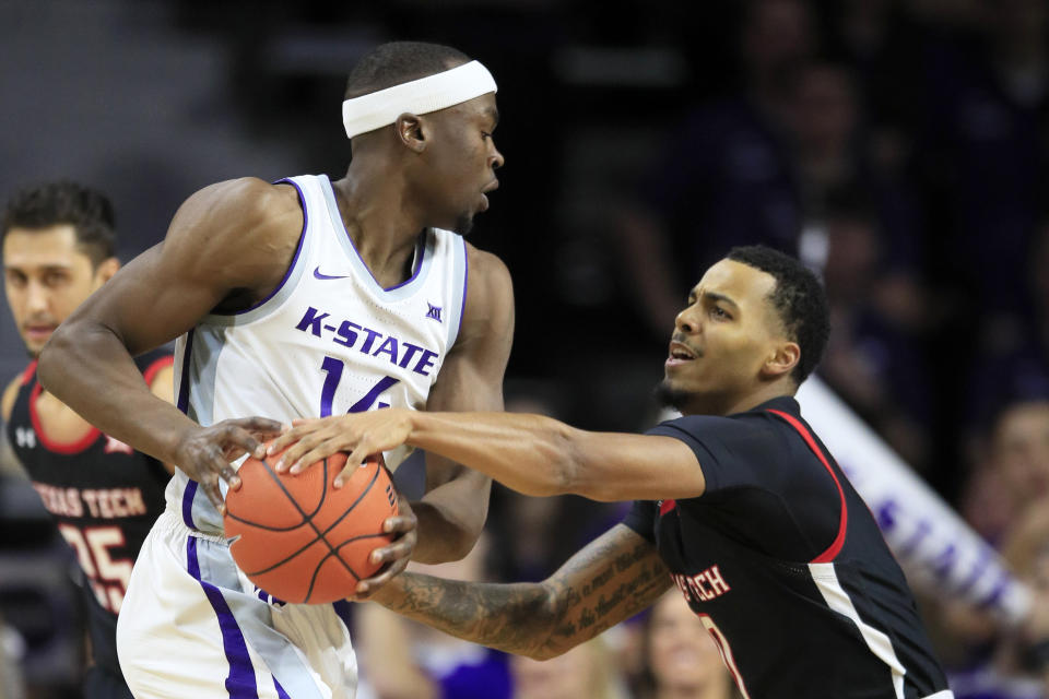 Kansas State forward Makol Mawien (14) is covered by Texas Tech guard Kyler Edwards, right, during the first half of an NCAA college basketball game in Manhattan, Kan., Tuesday, Jan. 14, 2020. (AP Photo/Orlin Wagner)