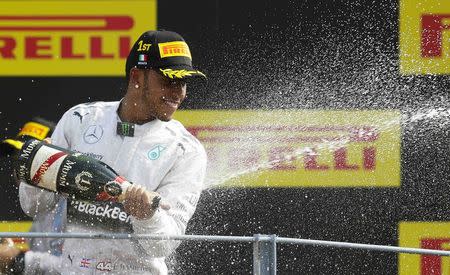 Mercedes Formula One driver Lewis Hamilton of Britain celebrates on the podium after winning the Italian F1 Grand Prix in Monza September 7, 2014. REUTERS/Max Rossi