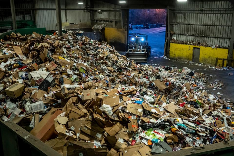 Piles of material brought in to be recycled at Resource Recovery and Recycling Authority of Southwest Oakland County in Southfield are moved before putting into machinery to be sorted and processed on Dec. 20, 2022.