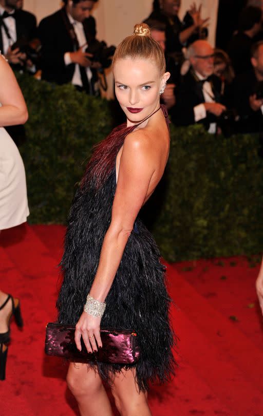 <p>For the Met Gala dedicated to “Prada: Impossible Conversations,” Kate Bosworth stood out in a flirty halter dress by the designer. The dark lip and top knot added some drama to the look. (Photo: Getty Images) </p>