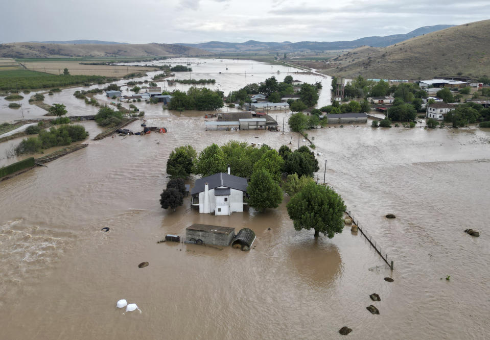 Floodwaters cover houses and farms after the country's record rainstorm in the village of Kastro, near Larissa, Thessaly region, central Greece, Thursday, Sept. 7, 2023. The death toll from severe rainstorms that lashed parts of Greece, Turkey and Bulgaria increased after rescue teams in the three neighboring countries recovered more bodies. (AP Photo/Vaggelis Kousioras)