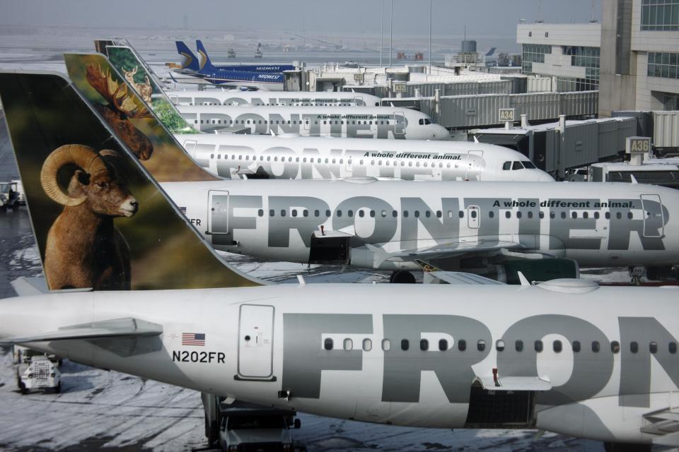 FILE - In this Monday, Feb. 22, 2010, file photo, Frontier Airlines jetliners sit stacked up at gates along the A concourse at Denver International Airport. Carriers are offering more deals to passengers who book flights directly on their websites. Frontier Airlines is the latest carrier to jump into the fight, announcing Wednesday, Sept. 12, 2012, that it will penalize passengers who don’t book directly with the airline. (AP Photo/David Zalubowski, File)