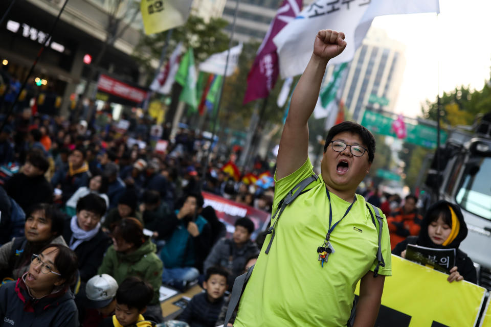 <p>A demonstrator raises a clenched fist during a protest ahead of President Donald Trump’s visit near the U.S. Embassy in Seoul, South Korea, on Saturday, Nov. 4, 2017. (Photo: Seong Joon Cho/Bloomberg via Getty Images) </p>