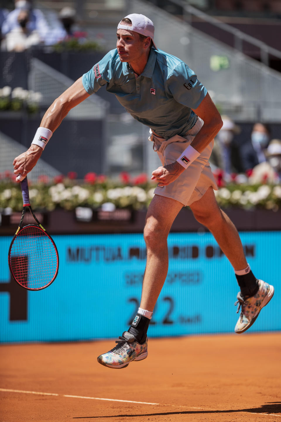 United States' John Isner serves to Austria's Dominic Thiem during their match at the Mutua Madrid Open tennis tournament in Madrid, Spain, Friday, May 7, 2021. (AP Photo/Bernat Armangue)