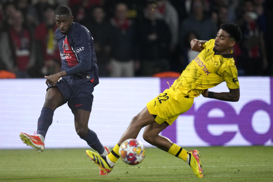 PSG's Ousmane Dembele, left, passes the ball past Dortmund's Ian Maatsen during the Champions League semifinal second leg soccer match between Paris Saint-Germain and Borussia Dortmund at the Parc des Princes stadium in Paris, France, Tuesday, May 7, 2024. (AP Photo/Christophe Ena)