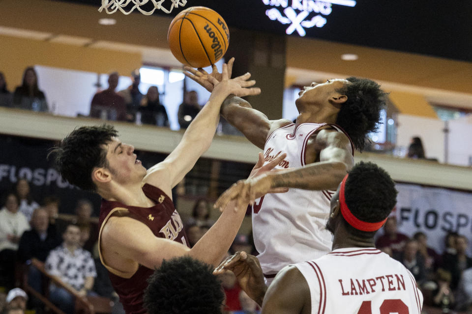 College of Charleston's Raekwon Horton, top right, fights for a rebound against Elon's Sam Sherry, left, in the first half of an NCAA college basketball game in Charleston, S.C., Saturday, Jan. 14, 2023. (AP Photo/Mic Smith)