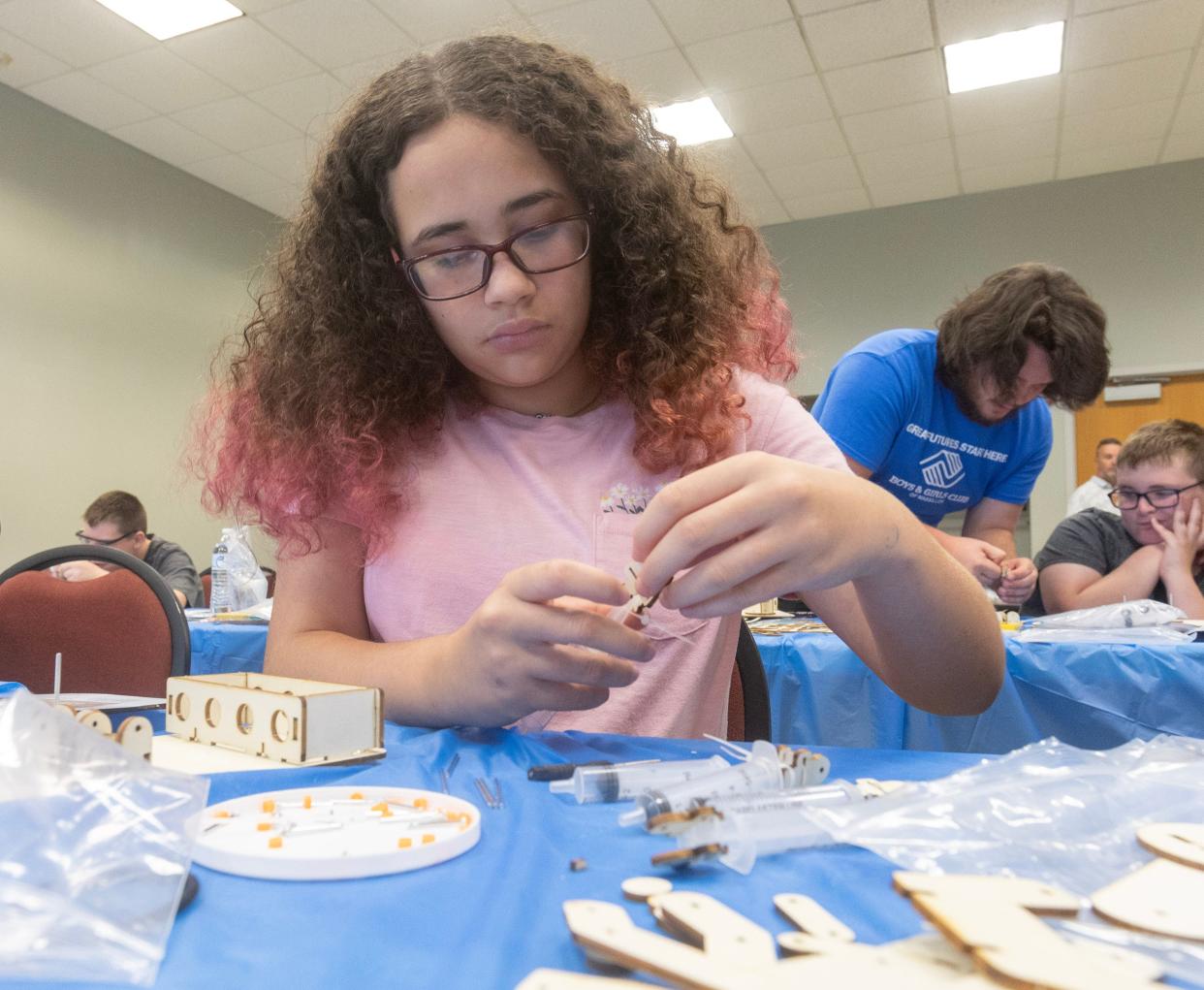 Amiya Fogg, 12, works Tuesday afternoon on building a replica hydraulic arm during the NASA Astro Camp at the Massillon Recreation Center. The hands-on camp began Monday and runs through Friday at the Rec Center.