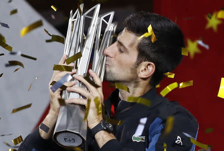 Tennis - Shanghai Masters - Men's Singles - Qi Zhong Tennis Center, Shanghai, China - October 14, 2018. Novak Djokovic of Serbia celebrates with the trophy after winning the final against Borna Coric of Croatia. REUTERS/Aly Song