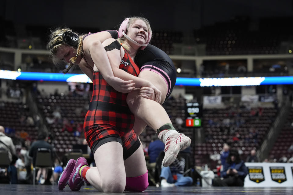 Cumberland Valley's Aja'nai Jumper, bottom, lifts Quakertown's Peyton Fries, top, during the first found of the PIAA High School Wrestling Championships in Hershey, Pa., Thursday, March 7, 2024. Girls’ wrestling has become the fastest-growing high school sport in the country. (AP Photo/Matt Rourke)