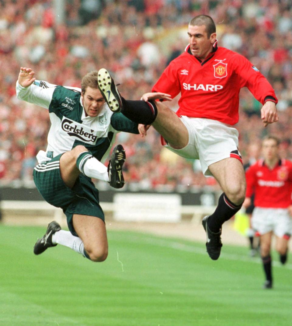 Manchester United's Eric Cantona, right and Liverpool's Jason McAteer collide in mid air while fighting for the ball during the second half of the English FA Cup final at London's Wembley Stadium Saturday May 11, 1996. Cantona went on to score the game's only goal in the final minutes of the game. Manchester United won the FA Cup and the English Soccer League title for the second time in three years.(AP PHOTO/ Max Nash)