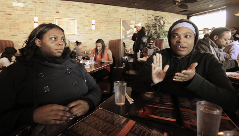 This Friday, Feb. 7, 2014 photo shows Christina English, right, a resident of Chicago's Bronzeville neighborhood resident, sitting with her friend Jeri Bryant from Cleveland, at a popular lunch spot speaking the possibility of a Barack Obama presidential library in the neighborhood. Bronzeville, the city’s historic center of black culture, business and politics, is one of six potential Chicago sites bidding to be the location for a presidential library, each backed by different interests. English, who works with special-needs children, said an Obama library would be great for the area. (AP Photo/M. Spencer Green)